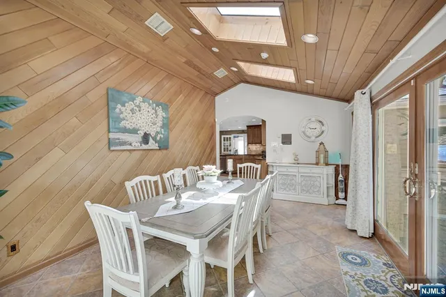 a view of a dining room with furniture and a chandelier