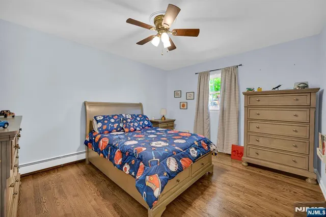 a bedroom with a bed and a ceiling fan