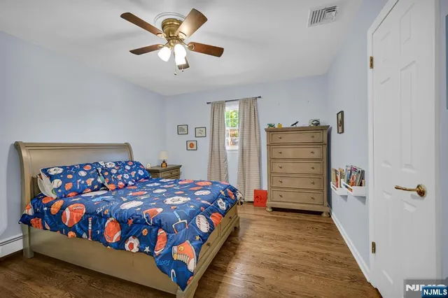 a bedroom with a bed closet and dresser