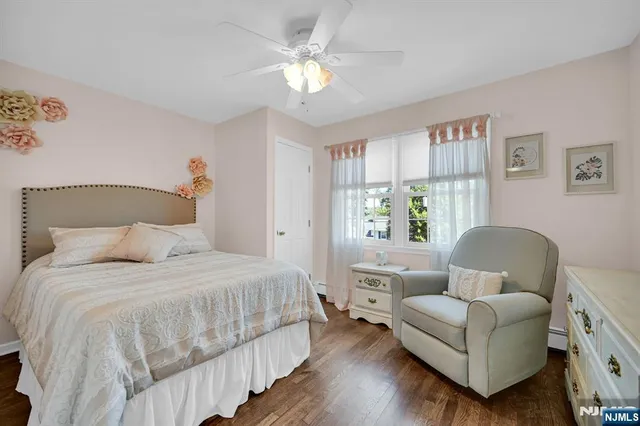 a bedroom with a bed couch and a window