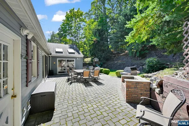 a view of a patio with table and chairs and potted plants