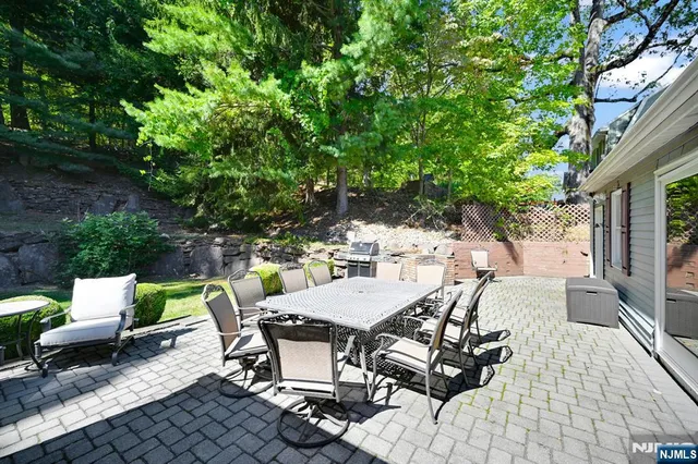 a view of a patio with table and chairs and potted plants