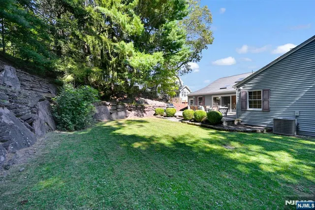 a view of a house with a backyard