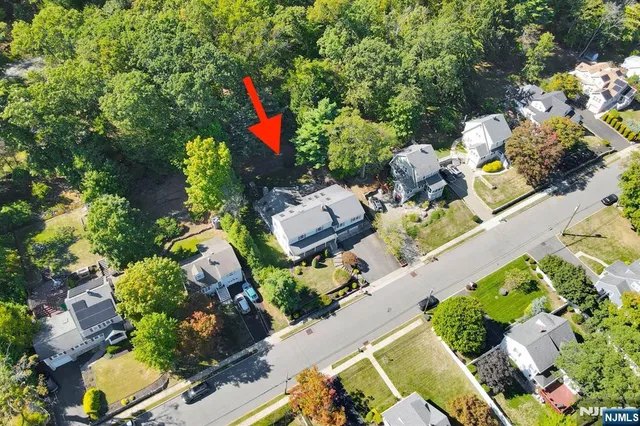 an aerial view of a house with a yard and a wooden fence