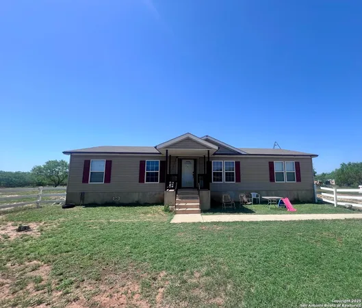 a front view of house with yard and green space