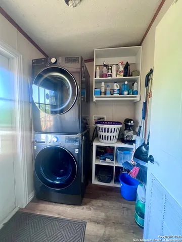 a kitchen with a stove and a wooden floor