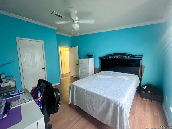 a bedroom with a bed and a ceiling fan