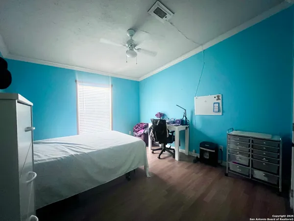 a bedroom with a bed and a potted plant