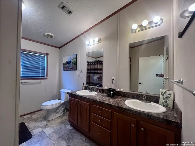 a bathroom with a toilet sink and mirror