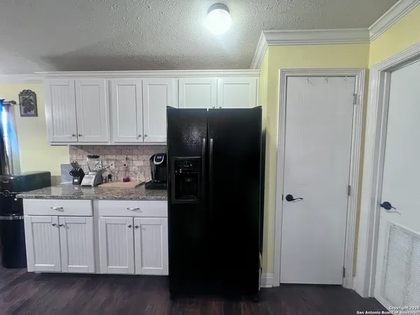 a kitchen with a refrigerator and cabinets