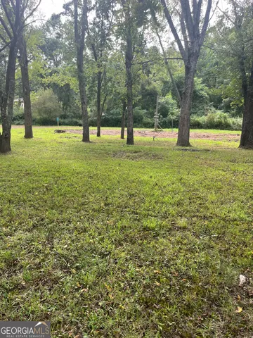 a view of outdoor space with deck and trees