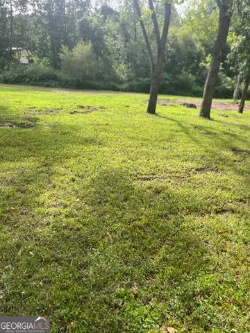 a view of yard with swimming pool