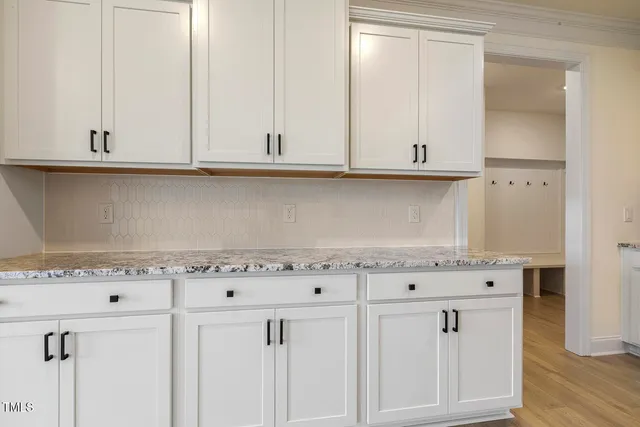 a kitchen with granite countertop white cabinets and a white wooden cabinets
