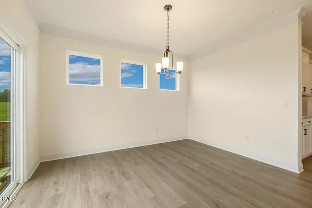 a view of a room with wooden floor staircase and a ceiling fan