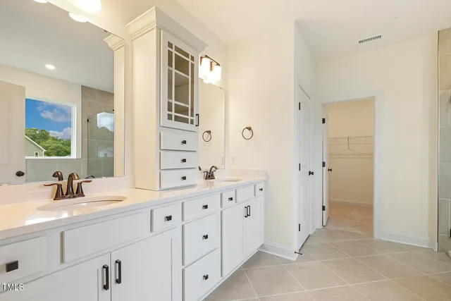 a spacious bathroom with a double vanity sink mirror and