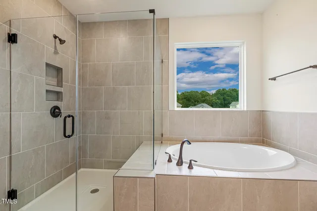 a bathroom with a tub and a shower