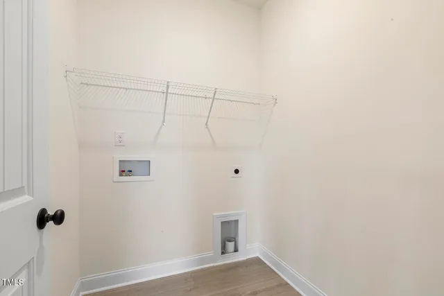 an empty room with windows and chandelier fan