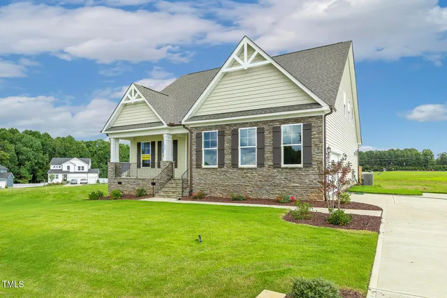 a front view of house with yard and outdoor seating