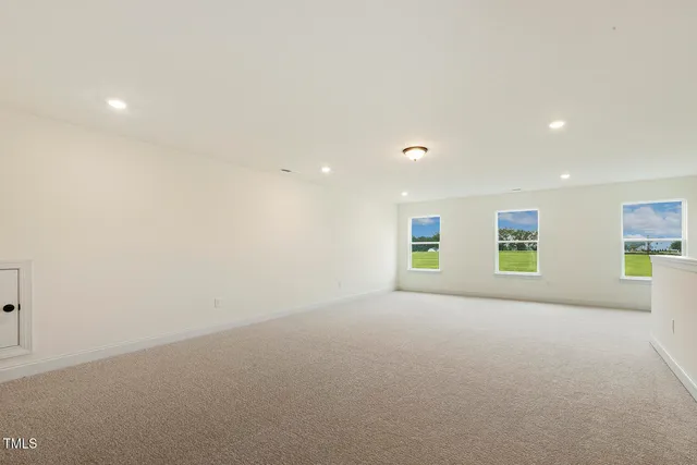 a bathroom with a granite countertop sink a toilet and a mirror