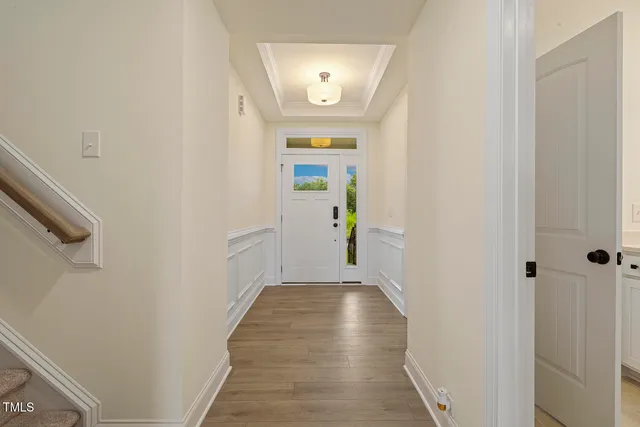 a view of a hallway with wooden floor