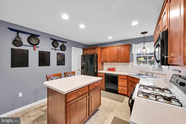 a kitchen with stainless steel appliances a sink stove and refrigerator