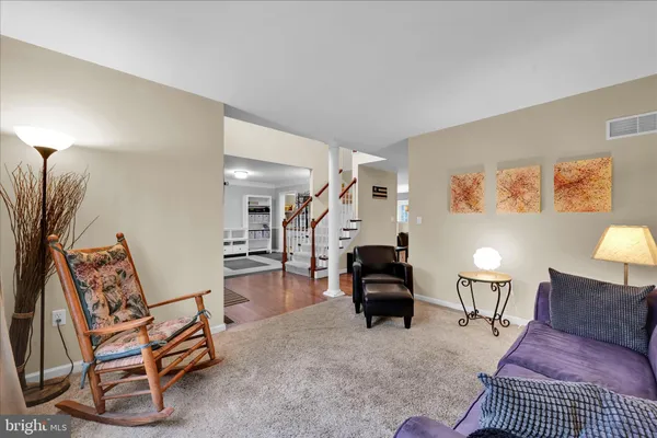 a living room with furniture and a lamp
