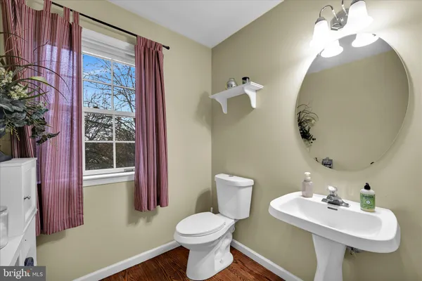 a bathroom with a sink toilet and a mirror