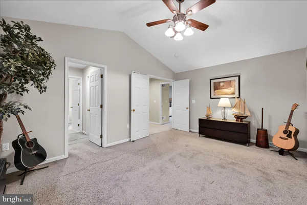 a view of a livingroom with furniture and a ceiling fan