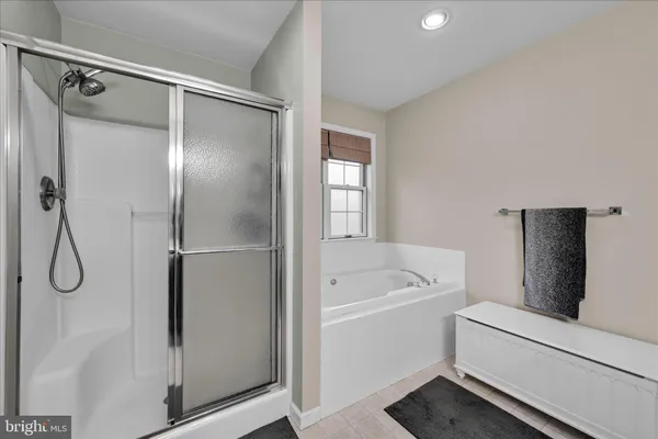 a bathroom with a tub shower vanity and a sink