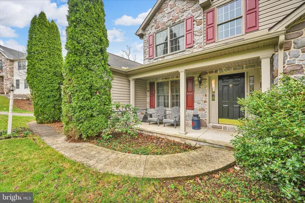 front view of a brick house with a small yard