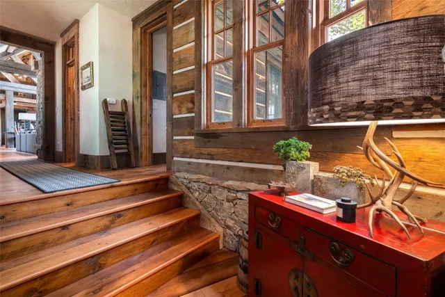 a bedroom with a bed a flat screen tv and a large window