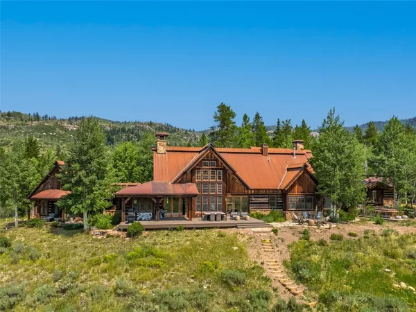 an aerial view of a house with swimming pool garden and mountain view