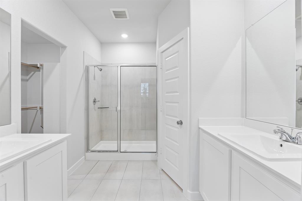 1322 Capecastle Lane Forney, TX 75126 - Photo 18 of 31 a bathroom with a shower sink and mirror