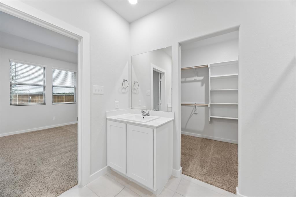 1322 Capecastle Lane Forney, TX 75126 - Photo 19 of 31 a bathroom with a sink a toilet and a window