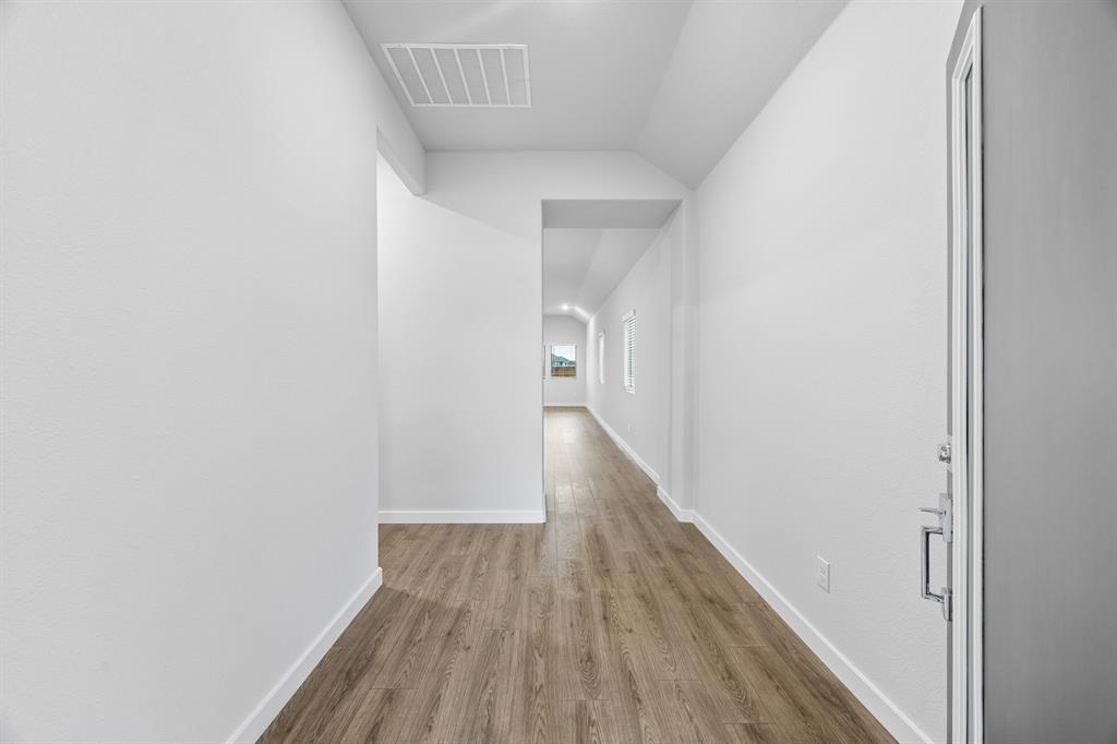1322 Capecastle Lane Forney, TX 75126 - Photo 27 of 31 a view of a hallway with wooden floor