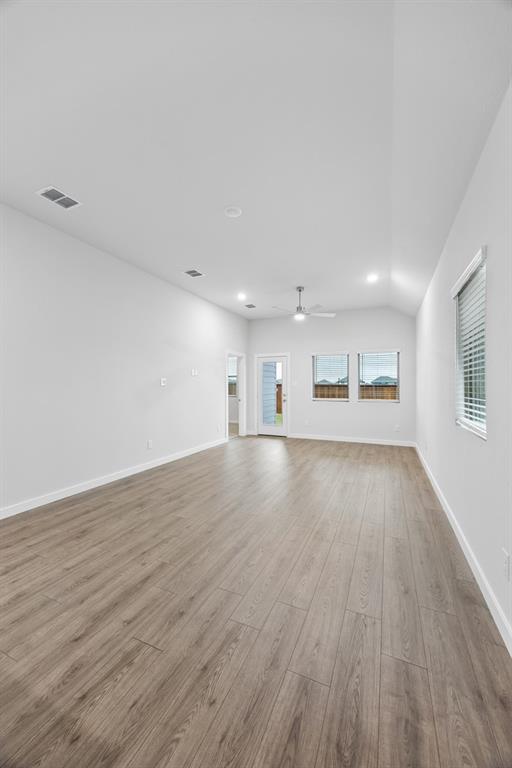 1322 Capecastle Lane Forney, TX 75126 - Photo 10 of 31 an empty room with wooden floor and windows