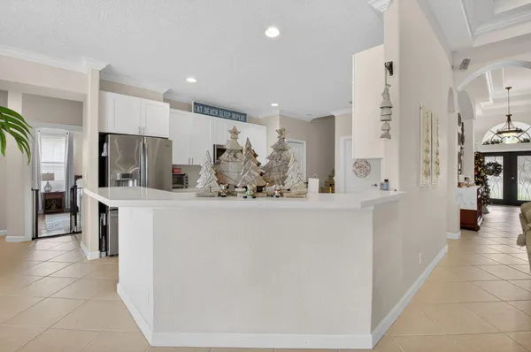 a view of living room kitchen with stainless steel appliances cabinets