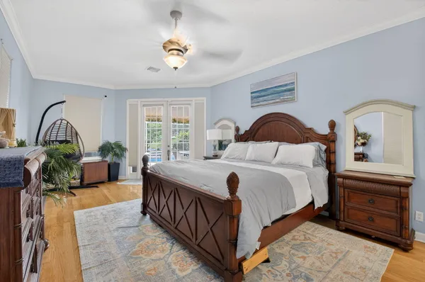 a bedroom with a bed and a dresser with the mirror