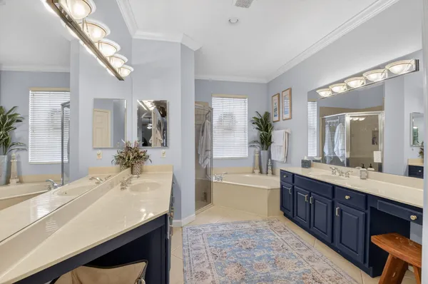 a spacious bathroom with a granite countertop sink mirror and bathtub