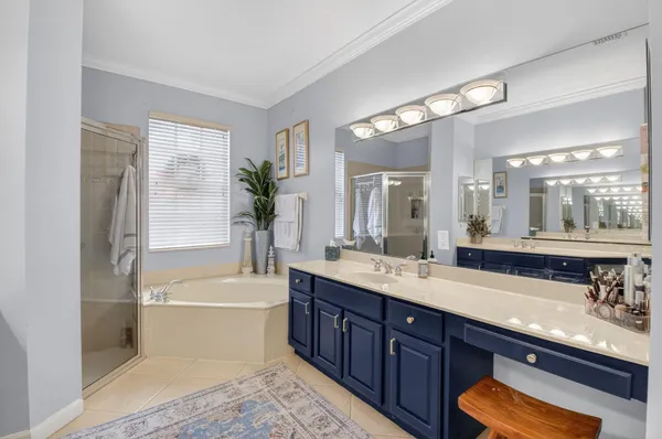 a bathroom with a tub double sink and mirror