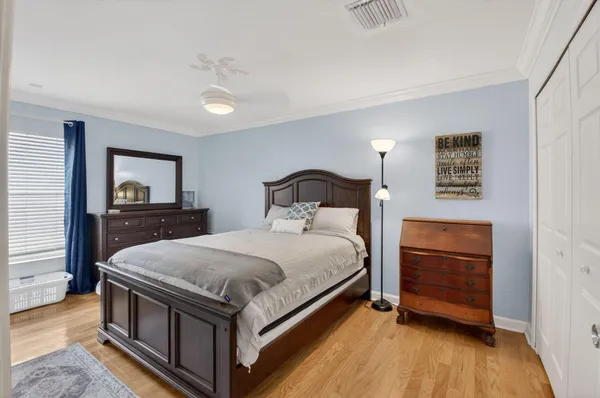 a bedroom with a bed and wooden floor