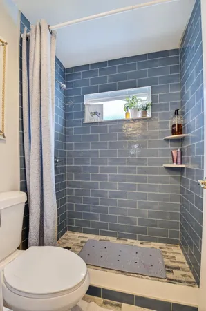 a bathroom with a toilet and shower