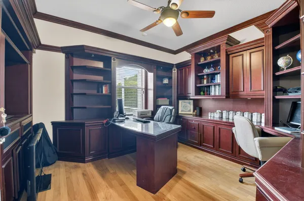 a living room with couches and kitchen view with wooden floor