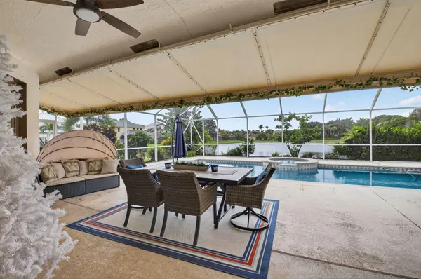 a view of a patio with chairs and table under an umbrella