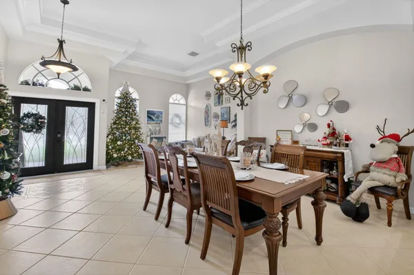 a view of a dining room with furniture and chandelier