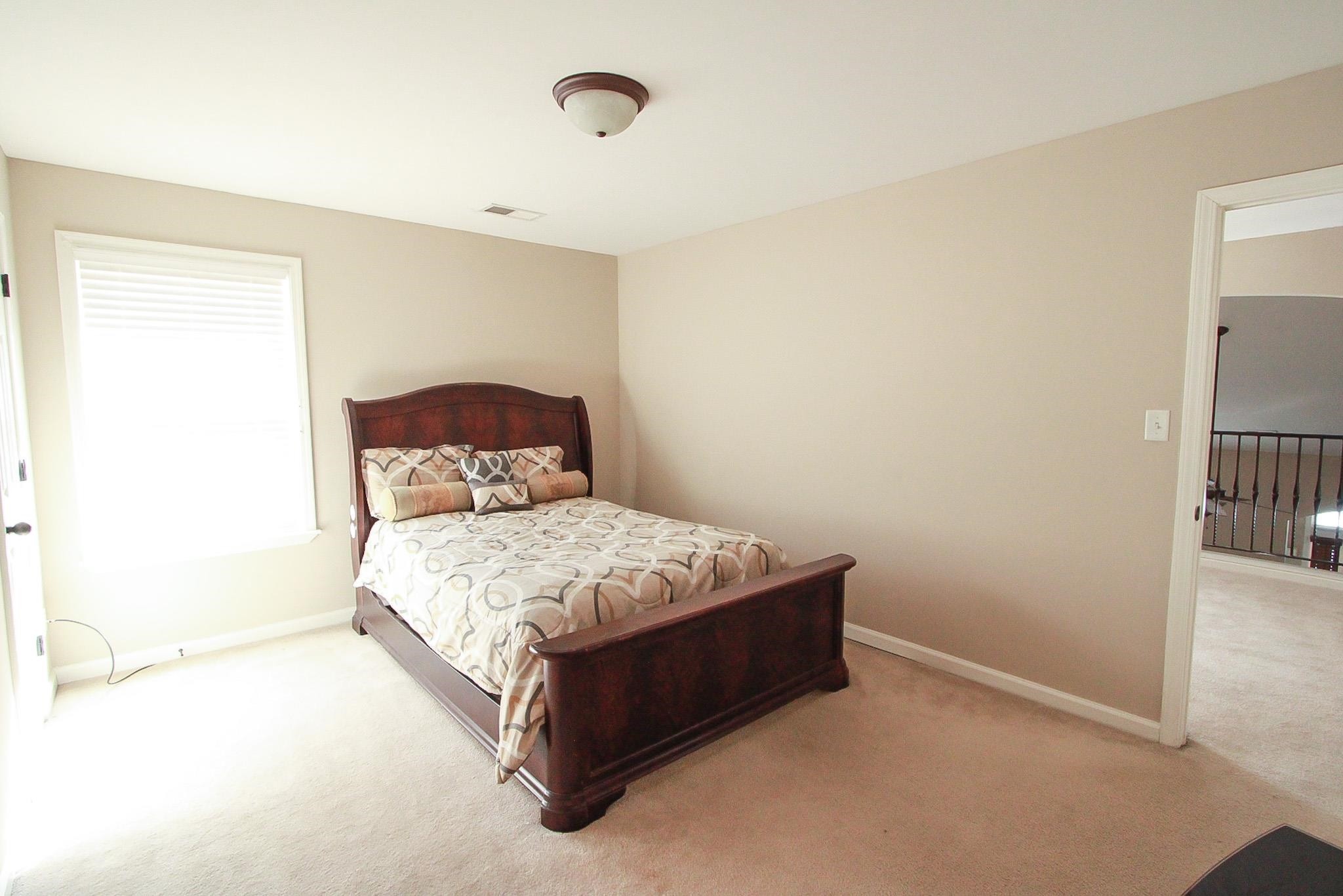 1818 North Houston Levee Road Cordova, TN 38016 - Photo 12 of 16 a bedroom with a bed and a table in it