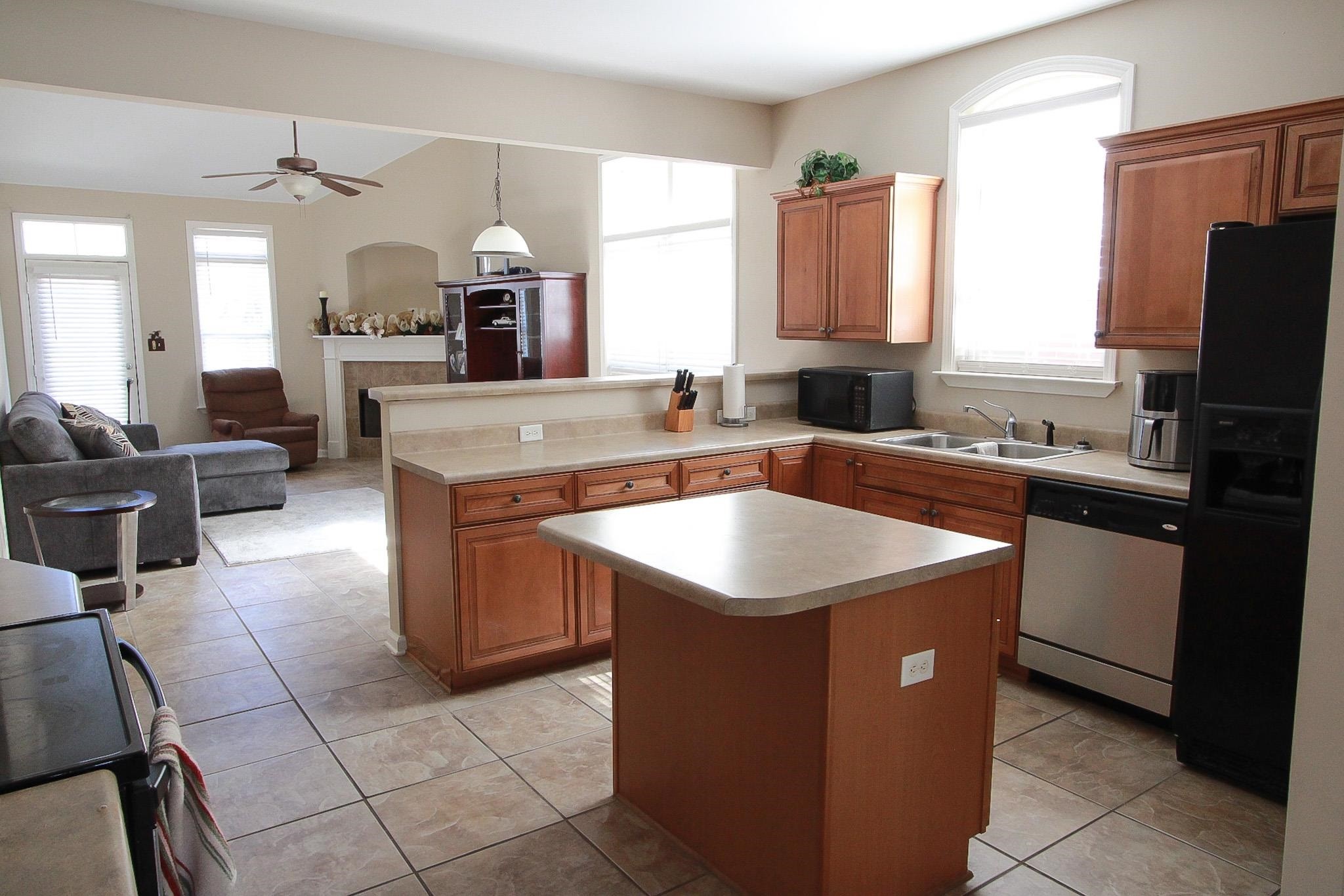 1818 North Houston Levee Road Cordova, TN 38016 - Photo 4 of 16 a kitchen with kitchen island a sink appliances and cabinets