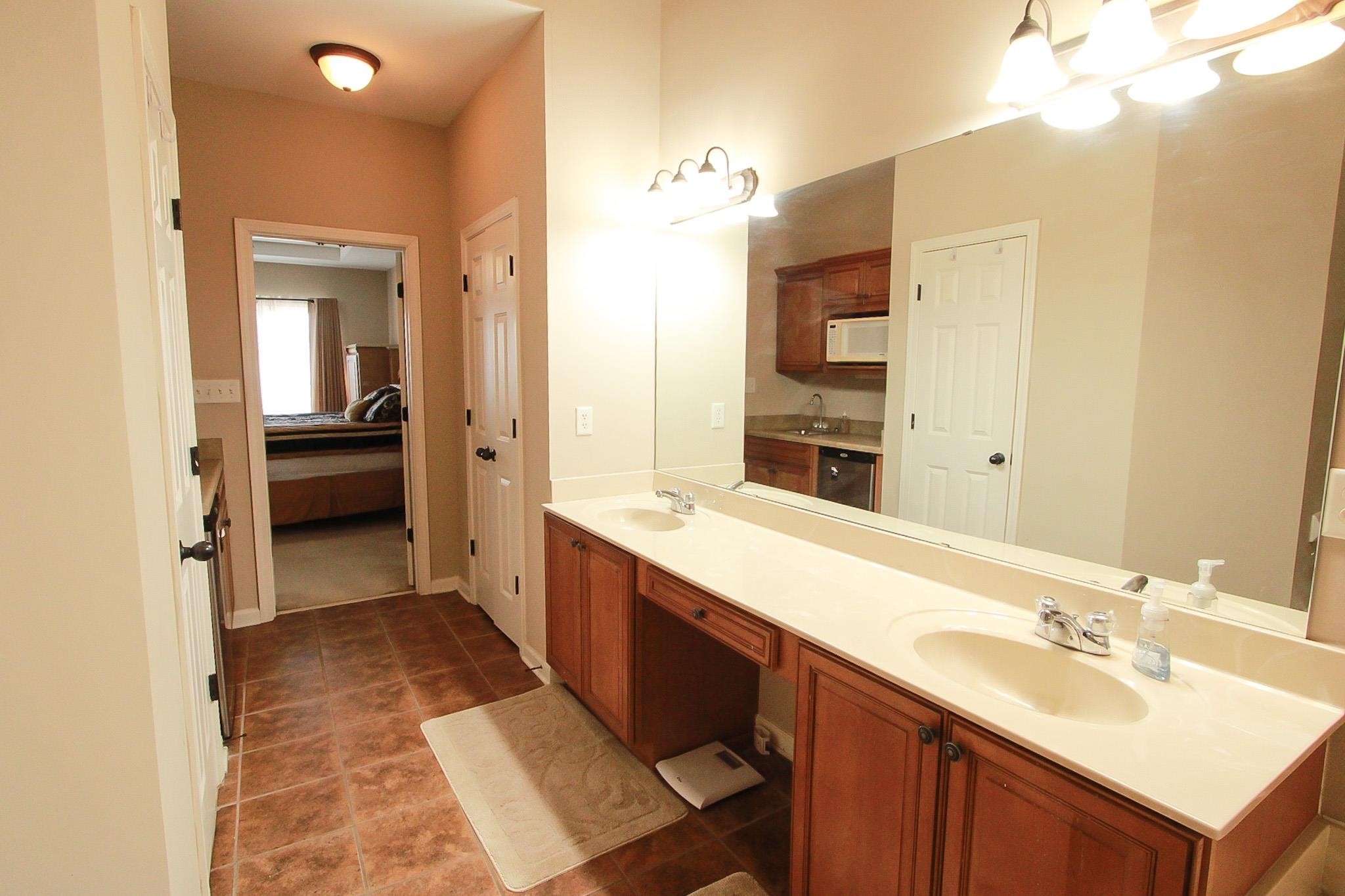 1818 North Houston Levee Road Cordova, TN 38016 - Photo 8 of 16 a spacious bathroom with a double vanity sink and a mirror
