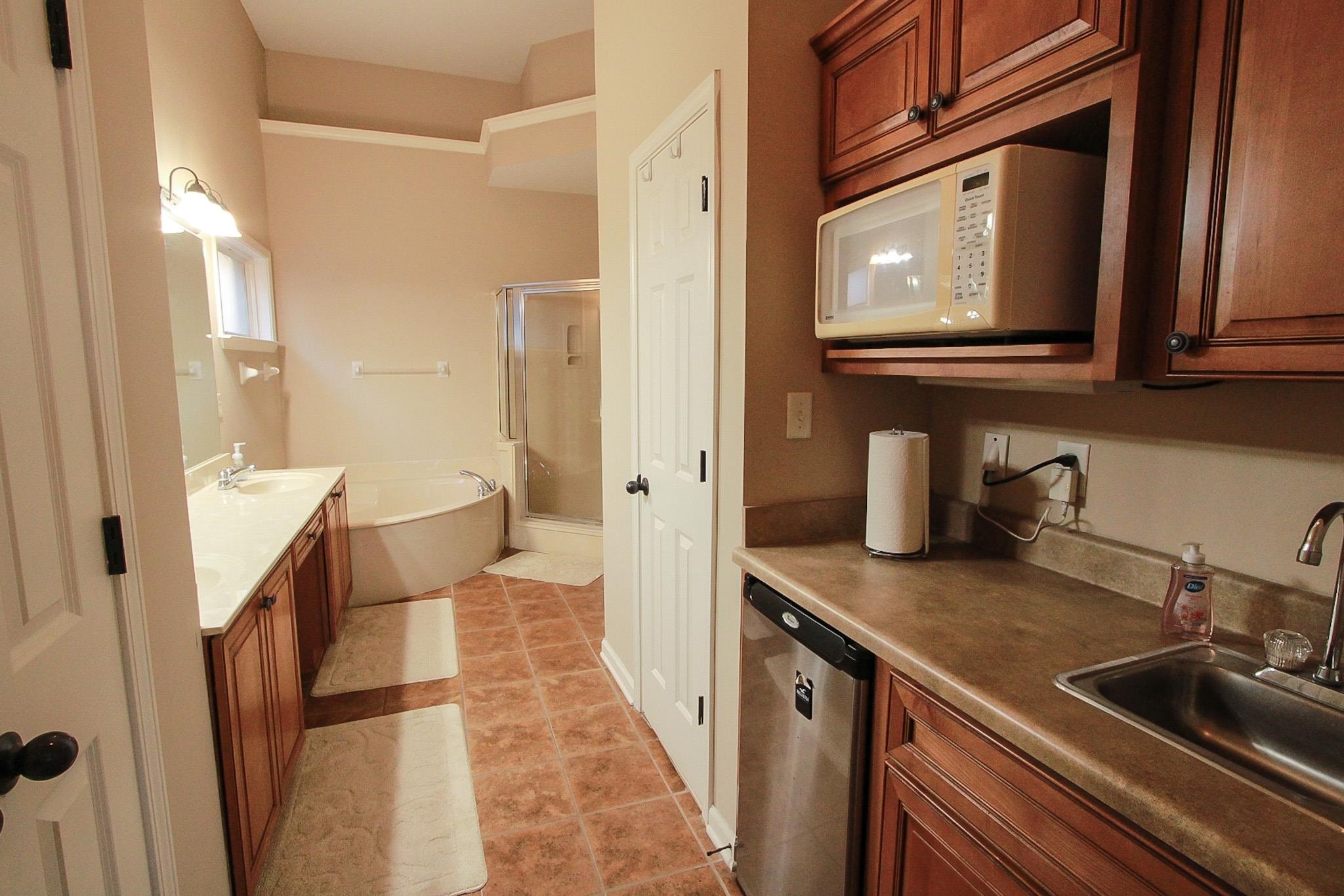 1818 North Houston Levee Road Cordova, TN 38016 - Photo 9 of 16 a view of a kitchen area with furniture and wooden floor