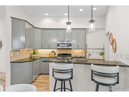 a kitchen with kitchen island stainless steel appliances a stove a sink and a refrigerator
